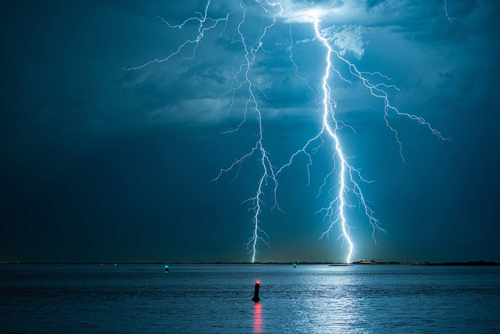 Bright branched lightning bolts strike down near the dutch coast